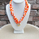 Tennessee Volunteers scarf necklace featuring a silky white and orange checkerboard scarf with a polished gold heart charm.