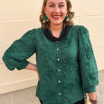 Hunter green 3D floral top with ruffled neckline, button-down front, and ¾-length puff sleeves.