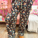 Person wearing floral pajama pants with a colorful background