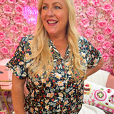 Dark floral satin pajama top with pastel flowers