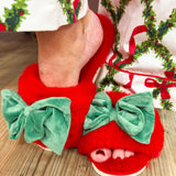 Red faux fur slippers with large green velvet bow