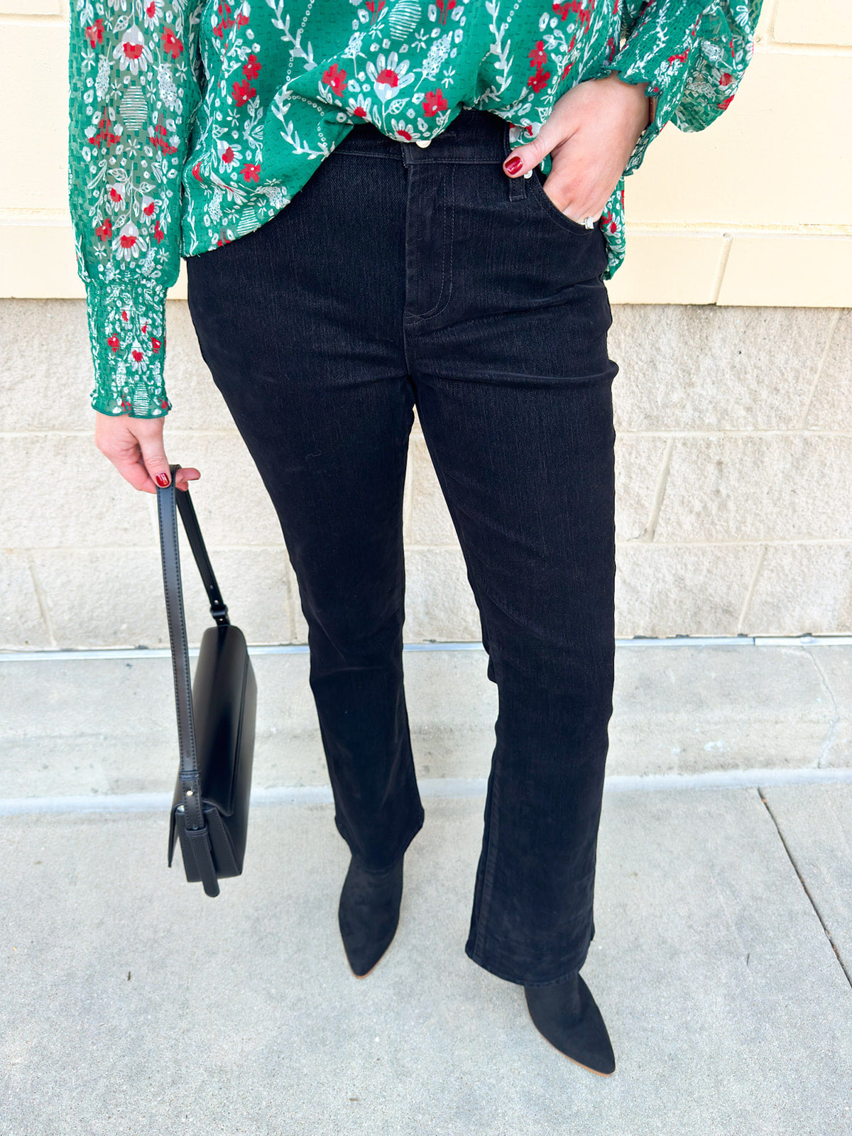 Women’s mid-rise velvet bootcut jeans in a classic fit, styled for dressy or casual occasions.