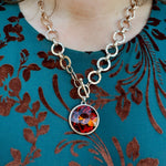 Gold chunky chain necklace with textured links and large amber crystal pendant