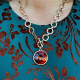 Gold chunky chain necklace with textured links and large amber crystal pendant