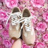 Neutral tan faux suede sneaker with cream and gold accents.
