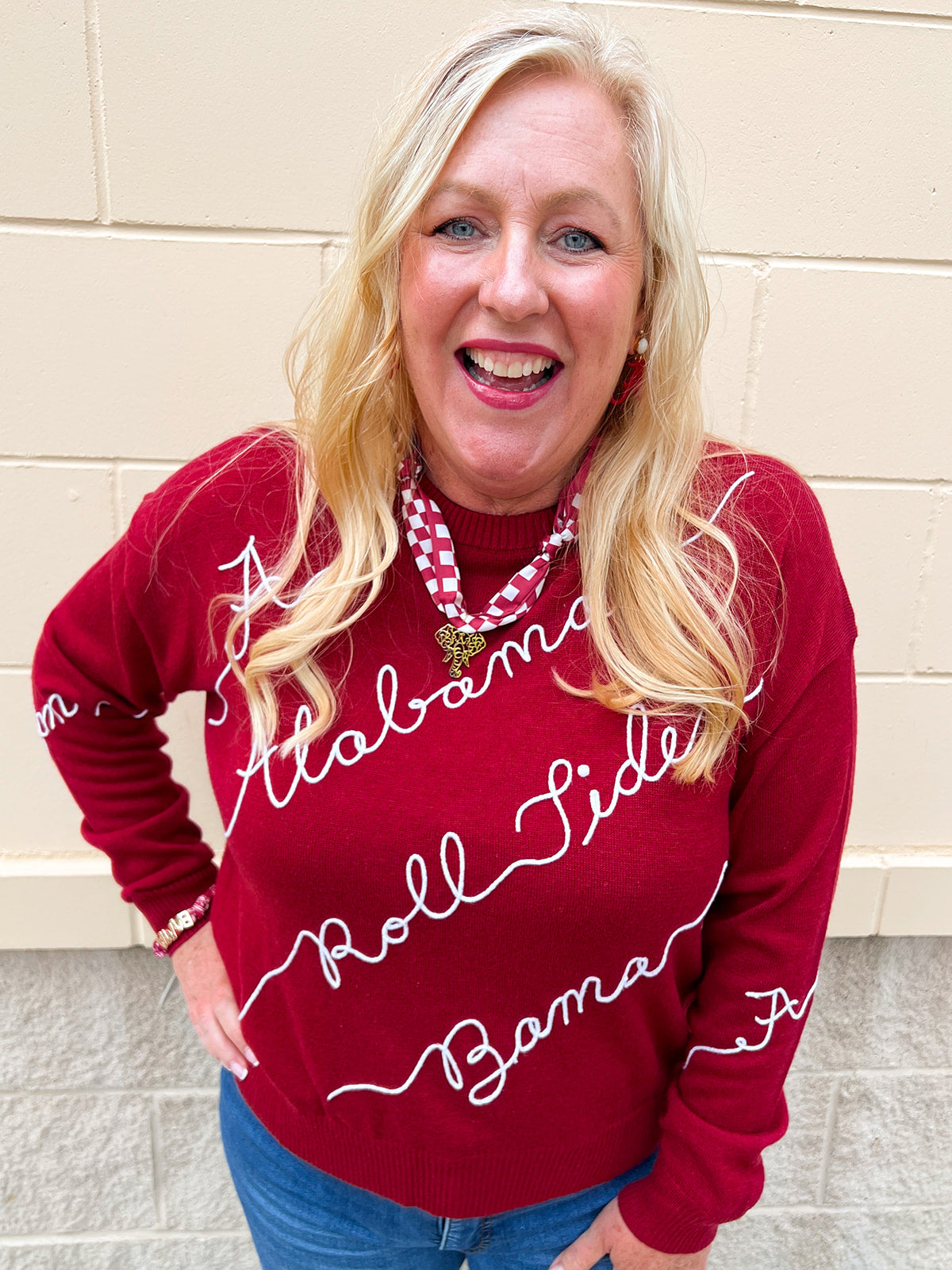 Red merino wool sweater with chain stitch embroidered Crimson Tide-inspired script and hand-drawn collegiate artwork.