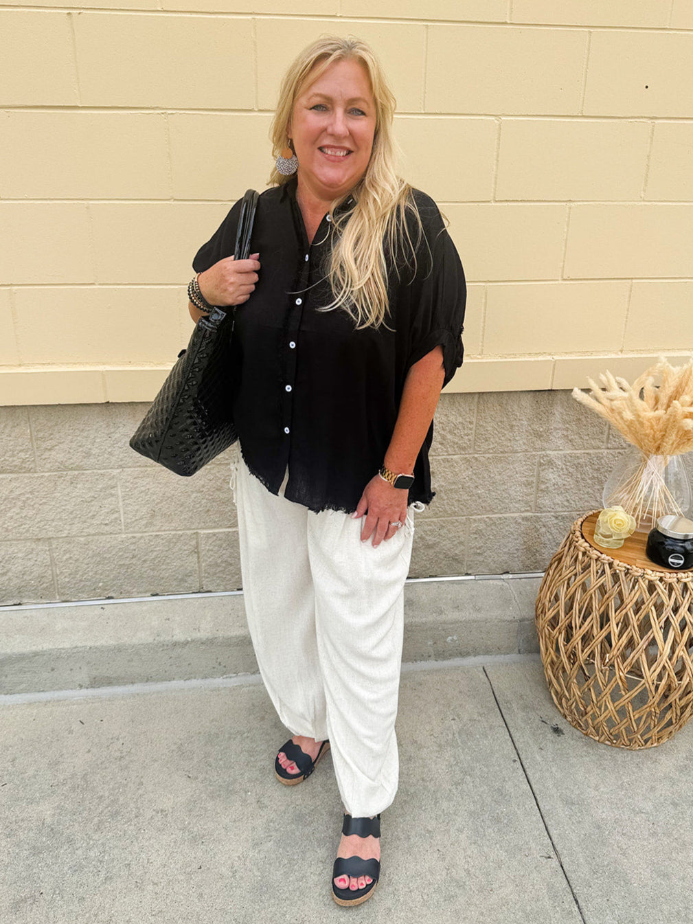 Relaxed fit oatmeal linen pants with gathered tie pockets and elastic cuffed ankles, styled with a top for an effortless warm-weather look.