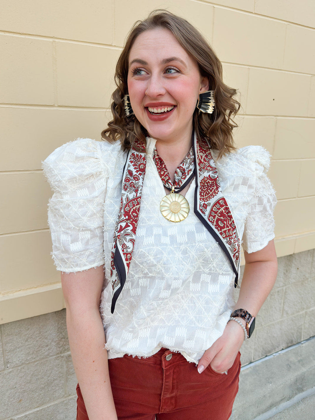 Cream puff sleeve textured top with ruffle collar and V-neckline, styled for fall layering.