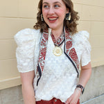 Cream puff sleeve textured top with ruffle collar and V-neckline, styled for fall layering.