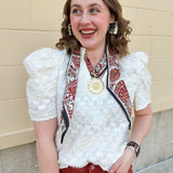Cream puff sleeve textured top with ruffle collar and V-neckline, styled for fall layering.