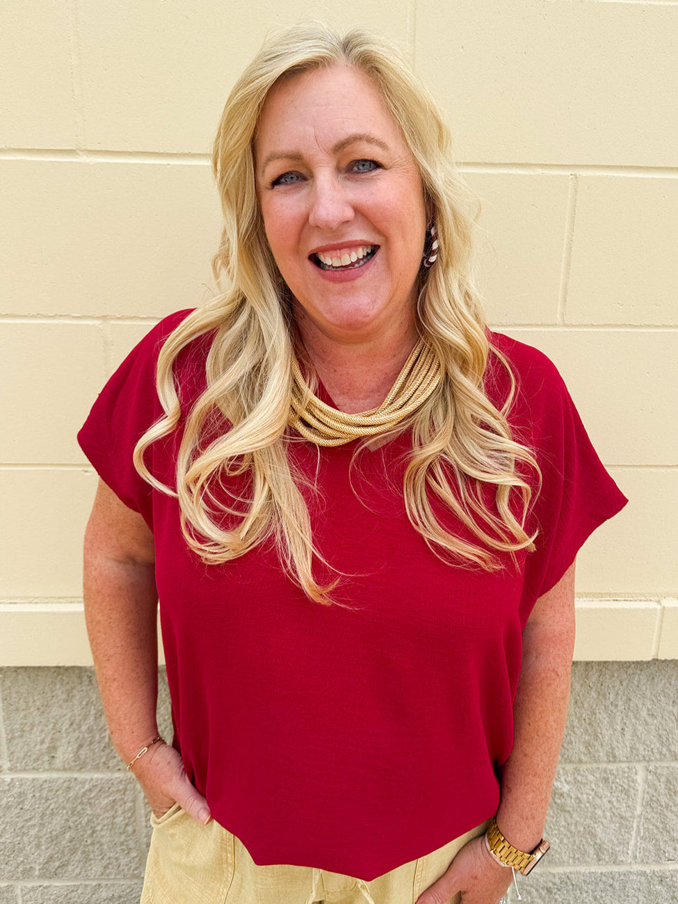 Garnet short sleeve top with V-neckline, cap sleeves, and back seam detail