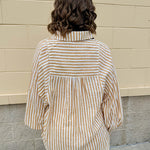 Tan and off-white striped long sleeve button-down shirt with collared neckline and cuffed sleeves—lightweight and perfect for layering
