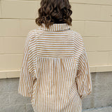 Tan and off-white striped long sleeve button-down shirt with collared neckline and cuffed sleeves—lightweight and perfect for layering