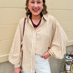 Tan and off-white striped long sleeve button-down shirt with collared neckline and cuffed sleeves—lightweight and perfect for layering