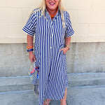 Navy and white striped maxi dress with collared neckline, full button front, cuffed sleeves, and flowing silhouette.