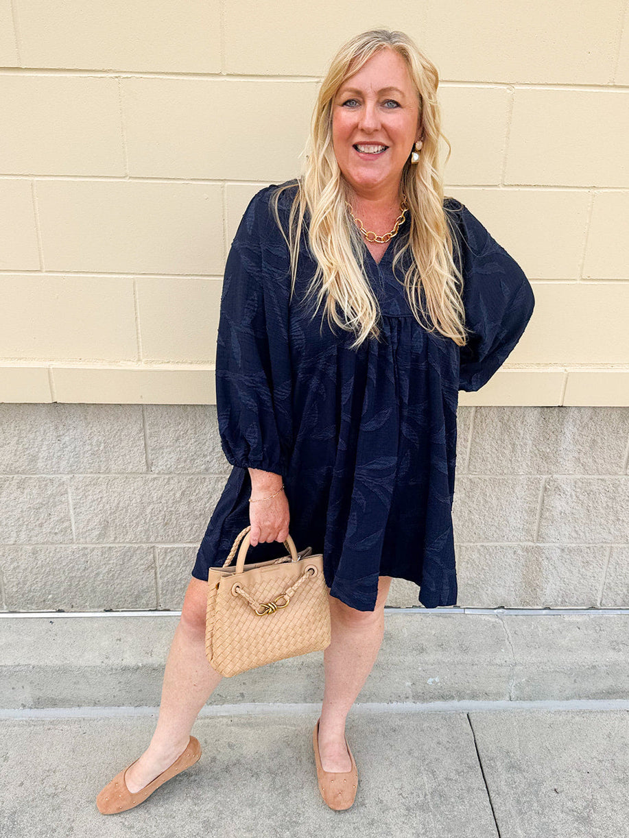Navy embroidered mini dress with v-neck, ruffle collar, and ¾-length cuffed sleeves