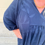 Navy embroidered mini dress with v-neck, ruffle collar, and ¾-length cuffed sleeves