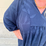Navy embroidered mini dress with v-neck, ruffle collar, and ¾-length cuffed sleeves
