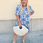 Blue and white damask print short-sleeve mini dress with pockets and back zipper closure, styled for a casual yet polished look.