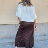 White long-sleeve knit sweater with contrasting brown buttons