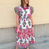 White cotton floral tiered maxi dress with flutter sleeves and ruffle collar