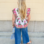 White cotton flutter sleeve top with floral print and ruffle neckline