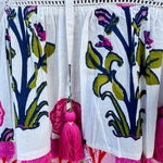 White cotton flutter sleeve top with floral print and ruffle neckline