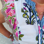White cotton flutter sleeve top with floral print and ruffle neckline