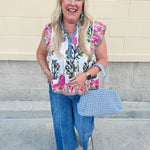 White cotton flutter sleeve top with floral print and ruffle neckline
