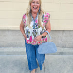 Medium wash wide leg jeans with mid rise, front seam, and front slits for a flattering, modern fit.