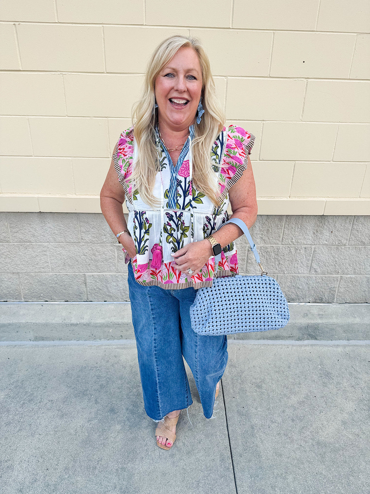 Medium wash wide leg jeans with mid rise, front seam, and front slits for a flattering, modern fit.