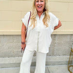 Oatmeal button-down top with gold trim, relaxed fit