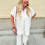 Oatmeal button-down top with gold trim, relaxed fit