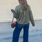 Deep green suede jacket with a classic collar and silver button-front closure