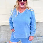 Santorini Indigo knit denim shorts with a high-rise drawstring waistband, side pockets, and contrast whipstitch detailing.