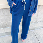 Indigo knit denim full-length pants with a mid-rise elastic drawstring waistband and side seam pockets.