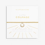 Gold ball stretch bracelet with a central circle charm adorned with gems.