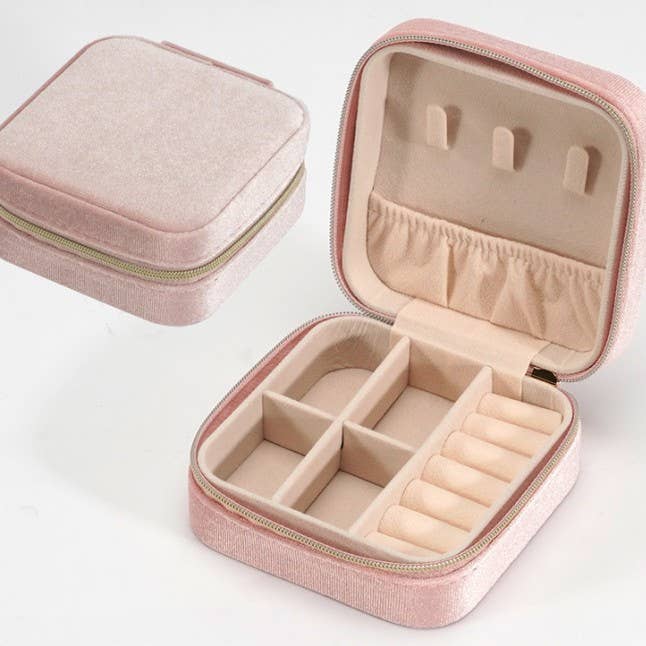 Pink velvet jewelry box organizer with top hooks, pouch, bottom compartments, and ring holder.