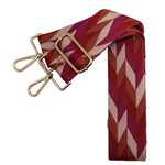 Stylish woven chevron bag strap with cream, burnt orange, light brown, and crimson pattern, finished with gold hardware.