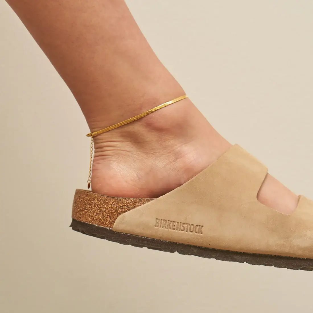 Gold herringbone anklet with sleek snake chain design