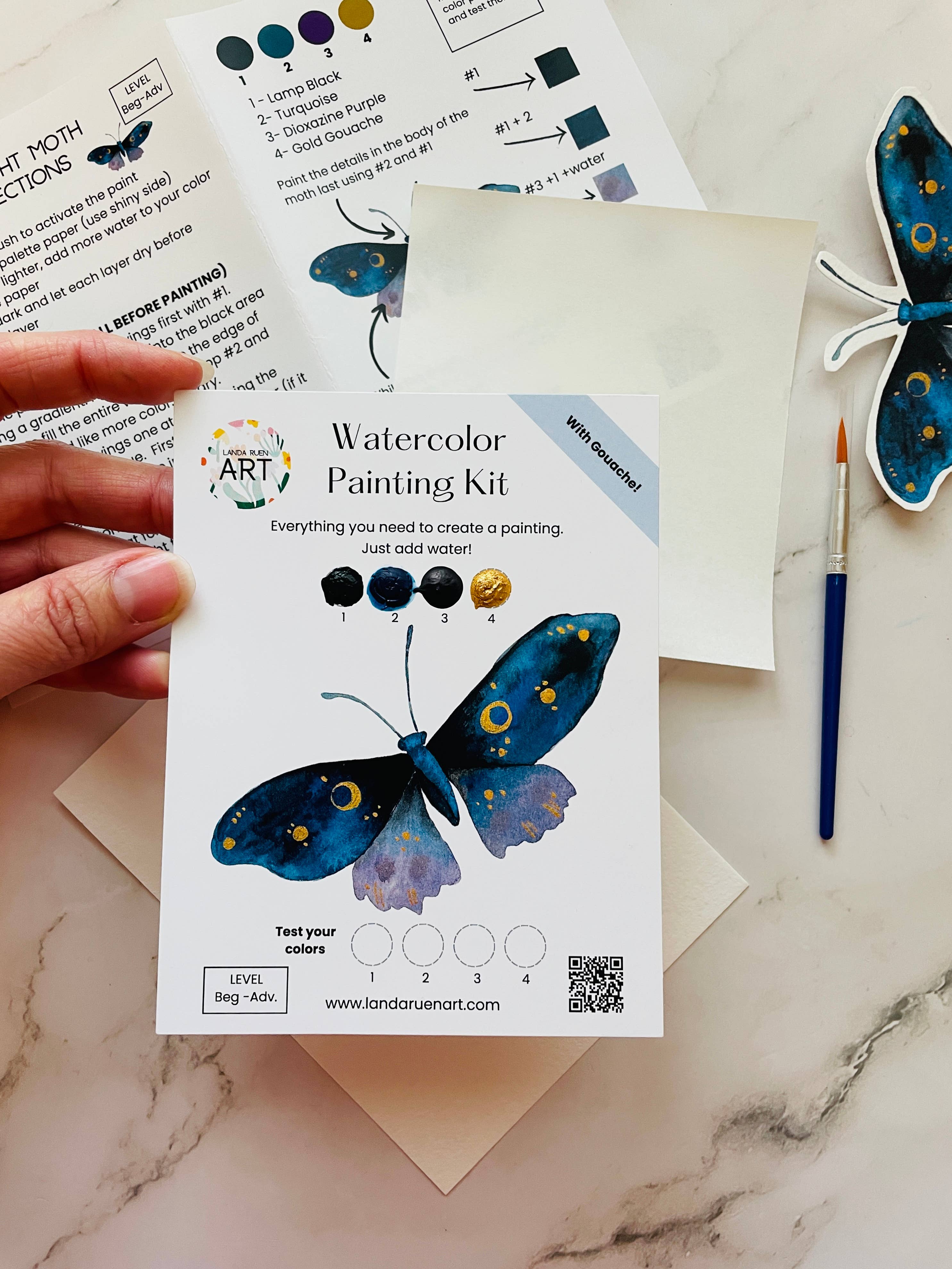 Midnight moth watercolor kit with professional watercolor paints, brush, palette paper, and heavy watercolor paper