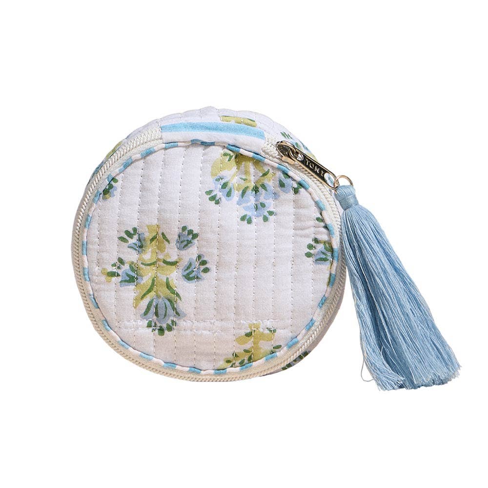 Round white quilted mini zip pouch with blue and green floral pattern and tassel zipper