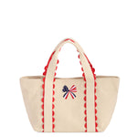 Cream canvas mini tote bag with red scalloped trim and embroidered American flag bow