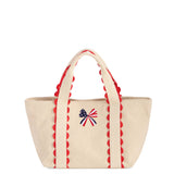Cream canvas mini tote bag with red scalloped trim and embroidered American flag bow