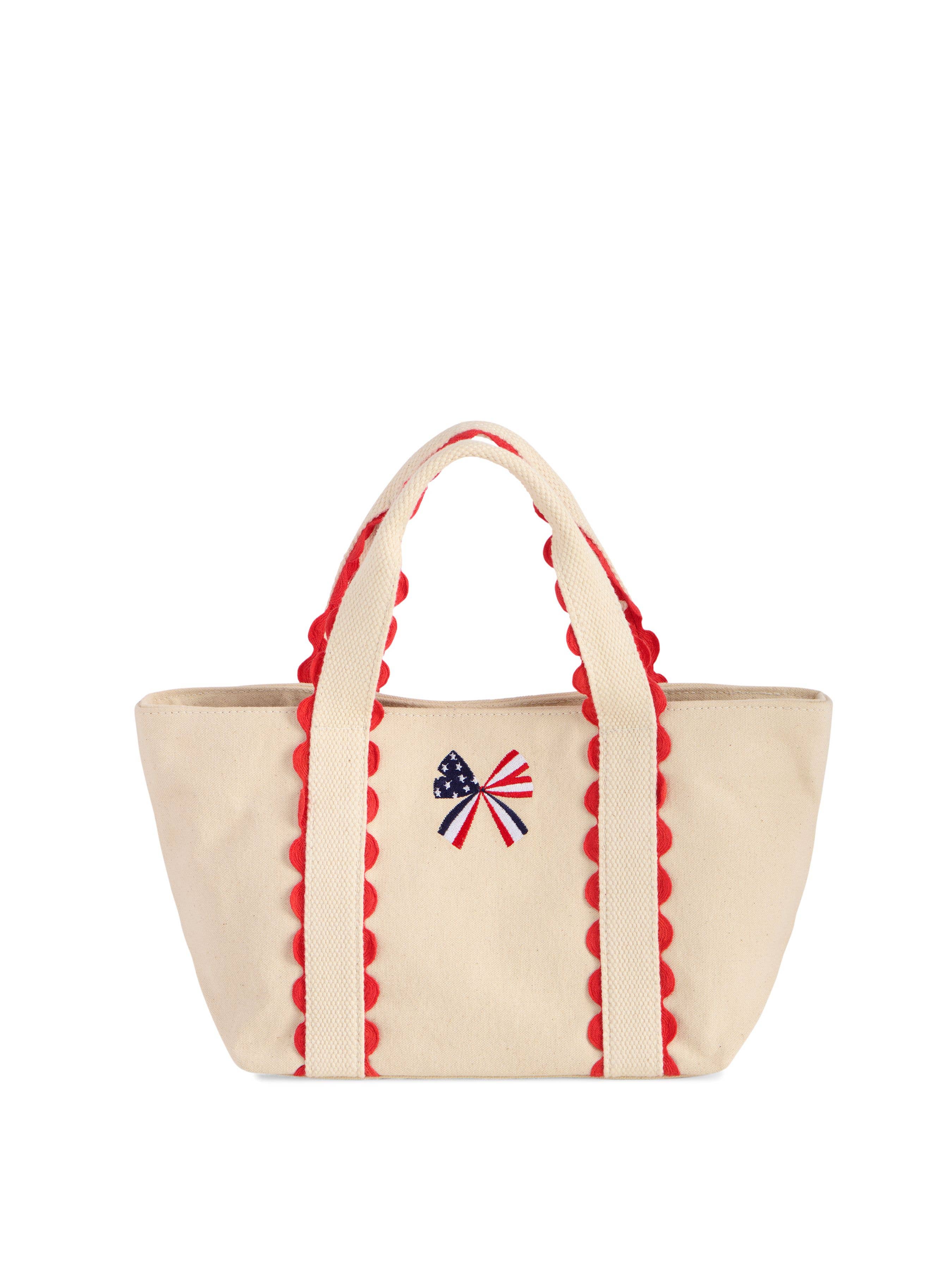 Cream canvas mini tote bag with red scalloped trim and embroidered American flag bow