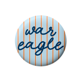 Auburn gameday button with light blue background, thin orange stripes, and dark blue cursive War Eagle lettering.