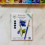 Violet February birth flower watercolor kit with floral outline, watercolor paints, paintbrush, and palette paper