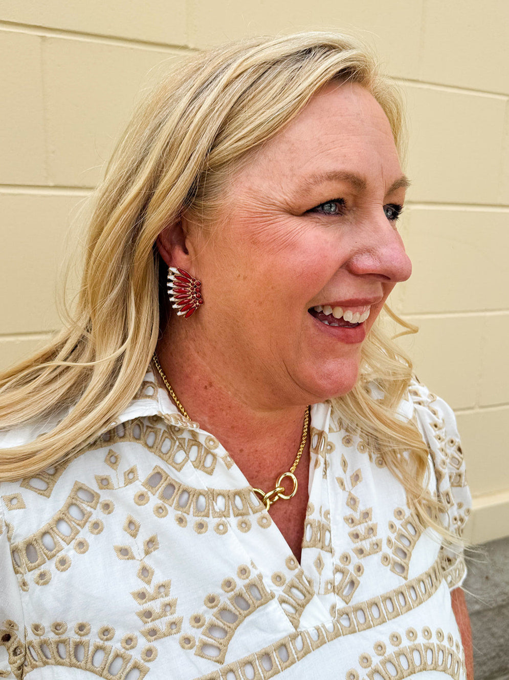 Gold-tone statement earrings with layered garnet and white enamel in a feather or starburst pattern—perfect for spirited Gameday style.