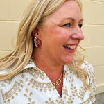 Gold-tone statement earrings with layered garnet and white enamel in a feather or starburst pattern—perfect for spirited Gameday style.