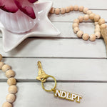 Gold "NDLPT" Keychain - The Pink Pineapple 850